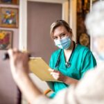 Nurse assessing patient records for care plan