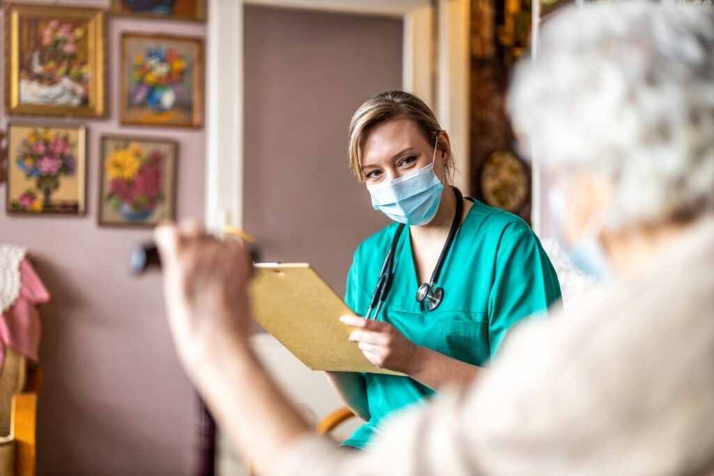 Nurse assessing patient records for care plan