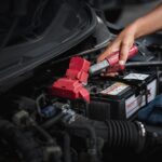 Dashboard lights dimming in a car, indicating a potential electrical fault.