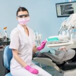 Dental hygienist reviewing patient charts as part of the assessment phase in dental hygiene diagnosis and care planning