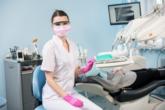 Dental Hygienist Examining Patient