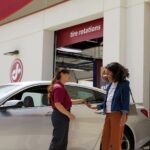 Woman in discussion with a Jiffy Lube technician about her car's diagnostic test results