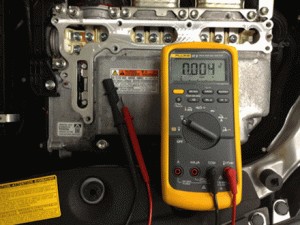 Technician applying electrical principles to diagnose car issue