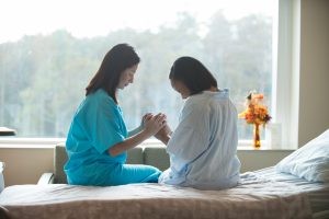 Nurse Praying with a Patient